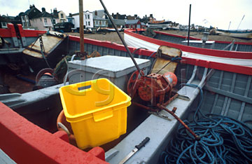 Comp image : boat0110 : Ropes and tackle in a red and pale blue fishing boat on the shore at Aldeburgh, Suffolk, England, with a bright yellow box