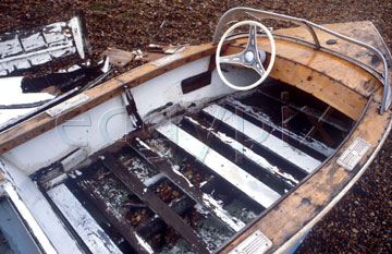 Comp image : dere0105 : Old speedboat rotting on the shingle, showing seat and steering wheel