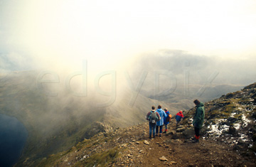 Comp image : ld00710 : Walkers look down through low cloud to Striding Edge from Hellvellyn, in the English Lake District