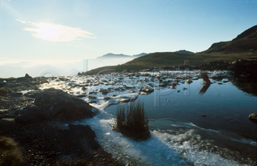 Comp image : ld00808 : Bright winter sun over the icy edge of Stickle Tarn, Langdale, in the English Lake District