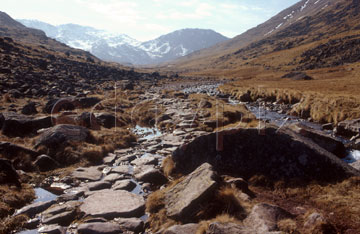 Comp image : ld02502 : On the rocky path to Sty Head in the English Lake District, in strong spring sunshine, with Scafell Pike and Lingmell in the distance under light snow