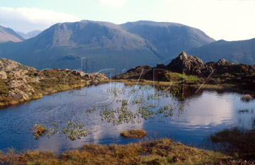 Comp image : ld03917 : Summer sky reflected in a small tarn near Haystacks, over Buttermere in the English Lake District, with Great Gable and Green Gable in the hazy background