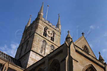 Comp image : lond010066 : Dramatic view looking up to the tower of Southwark Cathedral in London, England, in strong sun against a blue sky
