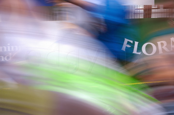 Comp image : mar022124 : A strong blur of runners in the London Marathon, with part of the sponsor's (Flora) roadside advertisement in the background