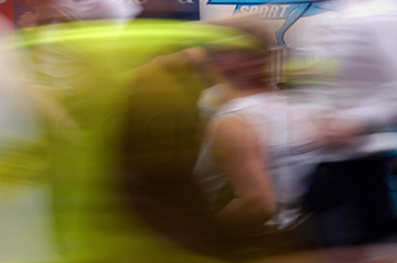 Comp image : mar022127 : The blur of runners in the London Marathon, with part of a roadside advertisement in the background