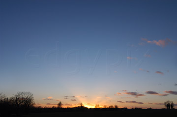 Comp image : sky020881 : The last rays of the sun through wispy clouds on the skyline under a big deep blue clear sky