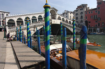 Comp image : ven021313 : The Rialto Bridge [Ponte di Rialto] (built 1591) over the Grand Canal [Canal Grande] in Venice, Italy, with boats and striped blue/green water markers in the foreground