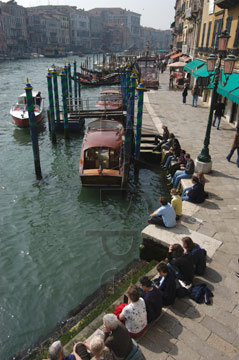 Comp image : ven021317 : The Grand Canal and Fondamenta del Vin seen from the Rialto Bridge in Venice; buildings along the canal in the distance, and people enjoying the sunshine in the forground