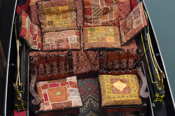 Comp image : ven021464 : Looking down on highly decorated cushions in a gondola on a canal in Venice, Italy