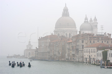 Comp image : ven021597 : A fleet of gondolas on the Grand Canal [Canal Grande] in Venice, Italy, with the church of Santa Maria della Salute (1687) visible through the mist in the background