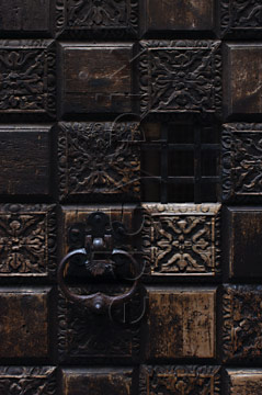 Comp image : ven021735 : Close-up of part of an old carved wooden door with a cast iron handle in Venice, Italy
