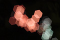 Abstract photo with overlapping pink and white translucent hexagons, the shapes suggesting a chemical model Abstract photo with overlapping pink and white translucent hexagons, the shapes suggesting a chemical model