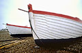 White fishing boats against a plain sky on the shingle at Aldeburgh, Suffolk, England White fishing boats against a plain sky on the shingle at Aldeburgh, Suffolk, England