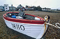 White and red fishing boat on the shingle at Aldeburgh, Suffolk, England White and red fishing boat on the shingle at Aldeburgh, Suffolk, England