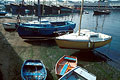 Boats on the shore at low tide, with strong shadows