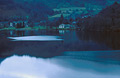 Autumn evening view across Ullswater to Glenridding, in the Lake District, with a reflection of St. Sunday Crag