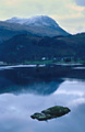 Autumn evening view across Ullswater to Glenridding, in the Lake District, with St. Sunday Crag in snow behind