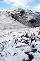 Snow-covered Crinkle Crags, Great Langdale, in the English Lake District, under a blue sky