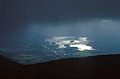 Misty sun on Derwentwater and Keswick, under very heavy cloud, seen from Skiddaw in the Lake District