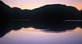 Reflected silhouette of the fells at sunset in the still waters of Buttermere, in the English Lake District