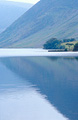 Delicate autumn reflection of the English Lake District fells in the still surface of Crummock Water, near Buttermere
