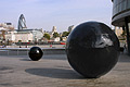 The 'black ball' sculptures outside London's City Hall; Sir Norman Foster's 'gherkin' on the skyline beyond