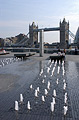 The dancing fountain near City Hall in the 'More London' development on the south bank of the Thames in London, England, with Tower Bridge in sun in the background