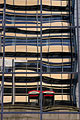 Distorted reflection in the glass of a London building, with two red telephone boxes