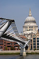 Suspension cables of the Millennium footbridge across the River Thames in London, England, with St. Pauls Cathedral in sunshine in the background
