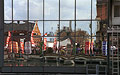 London Marathon 2000: reflection of the runners and red sponsor's signs in the glass wall of a building in the Docklands area of London, at about half distance