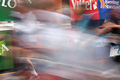 The blur of runners in the London Marathon, with parts of roadside advertisements in the background The blur of runners in the London Marathon, with parts of roadside advertisements in the background