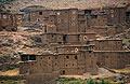 Mud brick buildings of a Berber village blending into the hillside in the High Atlas mountains of Morocco