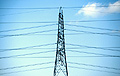 Electricity pylon and cables against a light blue sky Electricity pylon and cables against a light blue sky