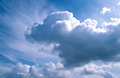 Big white cumulus clouds in a sunny blue sky