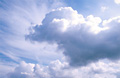 Big white cumulus clouds in a sunny blue sky