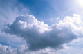 Big white cumulus clouds in a sunny blue sky