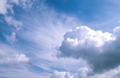 Big white cumulus and stratocumulus clouds in a sunny blue sky