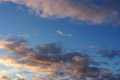 Two bands of pink tinted clouds against a blue evening sky