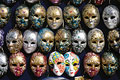 An arrangement of brightly decorated Carnivale masks on sale in Venice, Italy, makes a colourful pattern