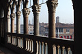 Silhouette of stone pillars and balustrade of the Ca' d'Oro (built between 1421 and 1440) in Venice, Italy, the buildings of the fish market just visible on the other side of the Grand Canal 