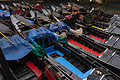 Strong composition of closely packed black gondolas with red and blue boards moored on a canal in Venice, Italy